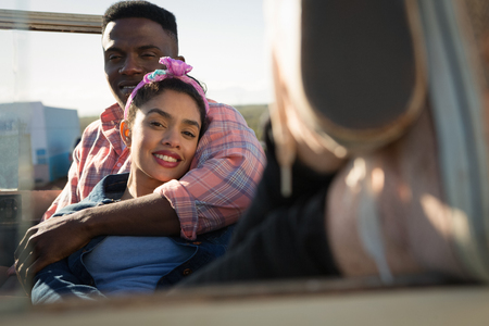 Couple relaxing together in car at countrysideの写真素材