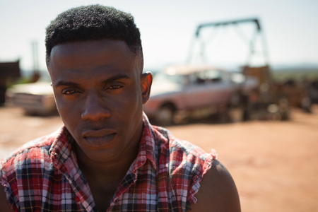 Portrait of man standing at petrol pump stationの写真素材