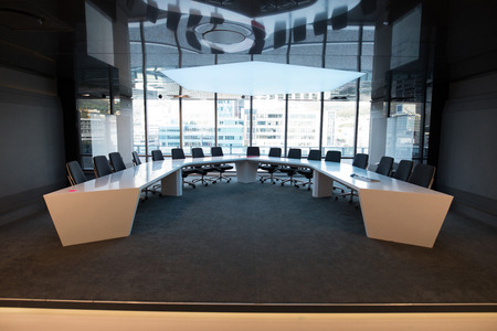 Empty chairs and table in boardroom