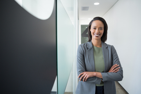 Portrait of confident businesswoman standing in corridorの写真素材