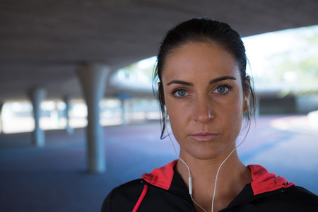 Portrait of fit woman standing in underground parking areaの写真素材