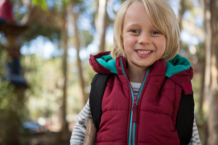 Close-up portrait of beautiful little girl with backpackの写真素材