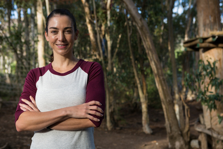 Portrait of woman folding her hands standing in forestの写真素材