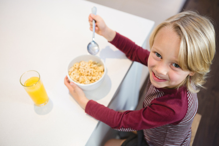 Portrait of boy having his breakfast at homeの写真素材