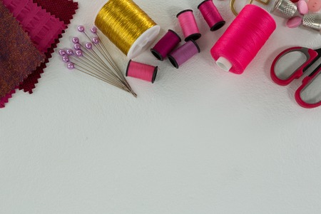 Overhead of thread rolls and tools on white backgroundの写真素材