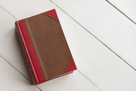 Close-up of a closed book placed on the floor at homeの写真素材