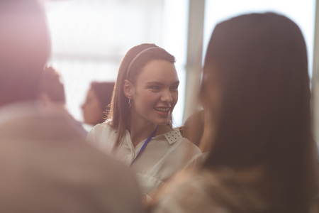 Side view of young Caucasian businesswoman attending a business seminar in office buildingの写真素材