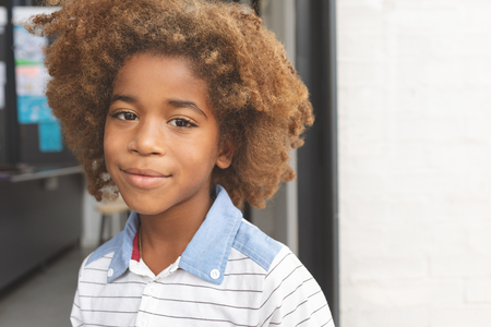 Front view of African ethnicity schoolboy smiling while looking at cameraの写真素材