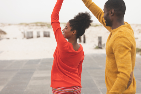 Front view of happy romantic Multi-ethnic couple dancing on pavement