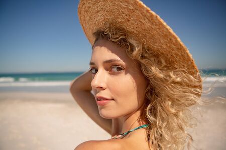 Portrait of Caucasian beautiful woman standing on the beach