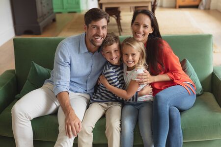Portrait of Caucasian family sitting together on sofa in living room art homeの写真素材