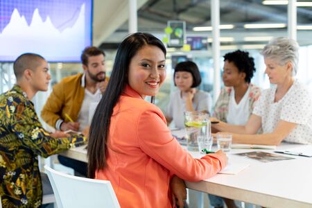 Side view of diverse business people discussing in the meeting at conference room in officeの写真素材