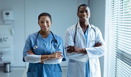 Portrait of diverse male and female doctors smiling in hospitalの写真素材