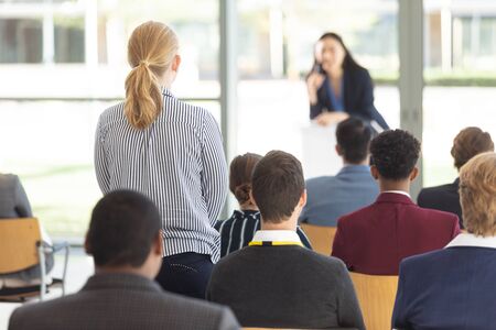 Front view of young Asian female executive doing speech in conference roomの写真素材