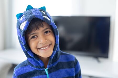 Front view of African american boy smiling in living room at homeの写真素材