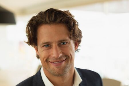 Portrait of smart young Caucasian businessman smiling in the conference room at office. New start-up business with entrepreneur working hardの写真素材