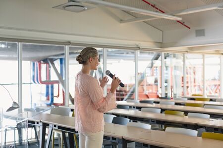 Side view of beautiful Caucasian female executive practicing her speech in the conference room at...