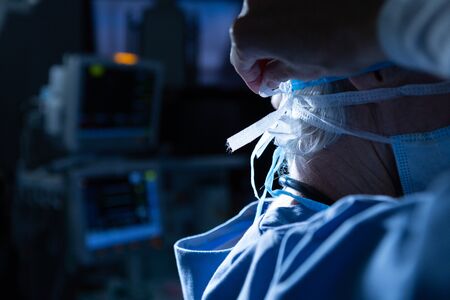 Side view of Caucasian female surgeon wearing surgical mask in operating room at hospital. Shot in...