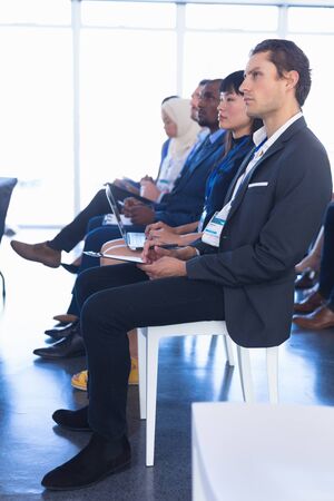 Side view of diverse Business people attending business seminar in conference meeting. International diverse corporate business partnership conceptの写真素材