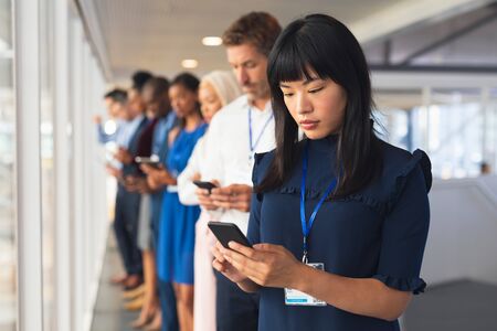Side view of diverse Business people using multimedia devices in business seminar at conference meeting. International diverse corporate business partnership conceptの写真素材