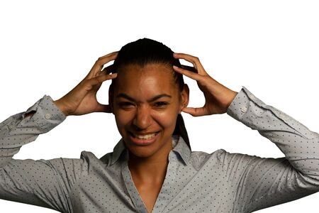 Portrait close up of a young mixed race woman looking to camera holding her head in frustration