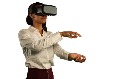 Side view close up of a young mixed race woman wearing a white shirt and a VR headset, looking ahead...