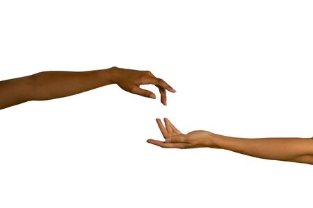 Close up of two arms, of a young Caucasian and a young mixed race woman, with hands reaching out...