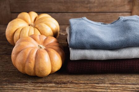 Autumn flat lay with clothes on wooden tableの写真素材