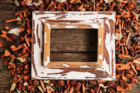 Autumn flat lay with photo frame on wooden table