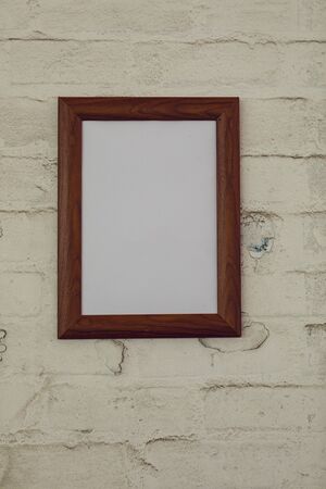 Close up of a framed blank picture hanging on a wall