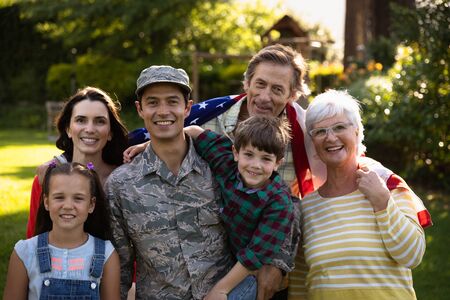 Soldier hugging his family in the garden