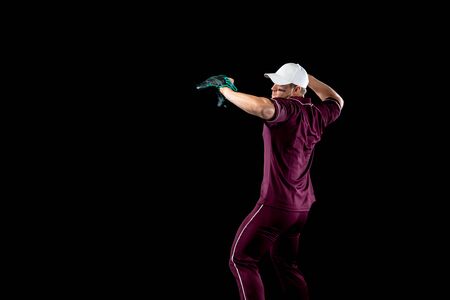 Side view of a Caucasian male baseball player, a pitcher or fielder, wearing a team uniform,...