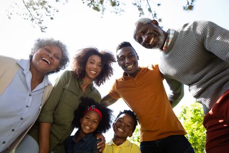 Low angle portrait of a multi-generation African American family in the gardenの写真素材