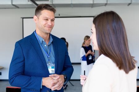 Side view of a Caucasian businesswoman and a Caucasian businessman working in a modern office
