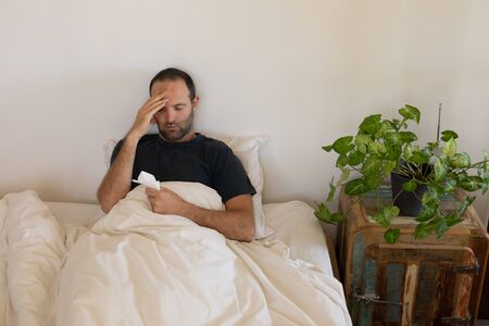 Sick Caucasian man spending time at home self isolating and social distancing in quarantine lockdown...