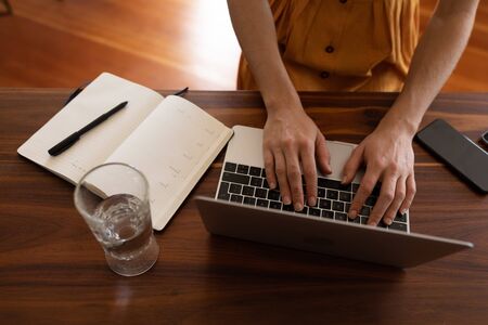 Mid section of Caucasian woman spending time at home self isolating and social distancing in...
