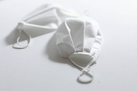 Close up of two white face masks protection against pandemic coronavirus covid 19 and for safety...