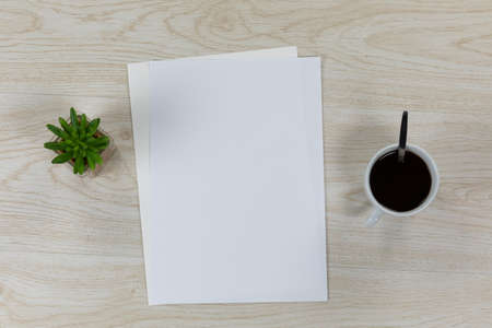 Top view of a variety of stationery pieces of white paper in various sizes, arranged on a textured...