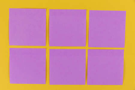 Close up top view of six purple sheets of paper sticky memo notes in one size, arranged on a plain...