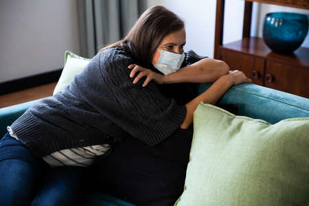 Caucasian woman spending time at home, social distancing and self isolation in quarantine lockdown,...