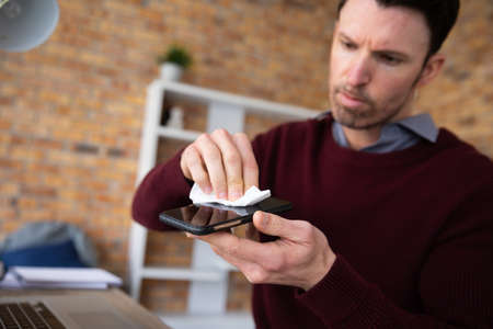 An attractive confident Caucasian professional man with dark hair wearing smart, casual clothes in...