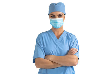 Portrait of Caucasian female doctor wearing face mask and scrubs with arms crossed looking at camera...