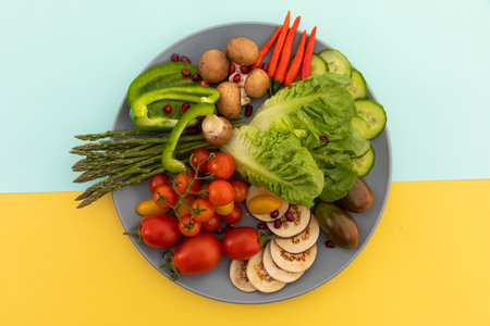High angle view of freshly cut vegetables on grey plate. fresh vegetables vitamins healthy whole food copy space concept.の写真素材