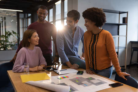 Diverse group of business people working in creative office. group of people in a meeting discussing...