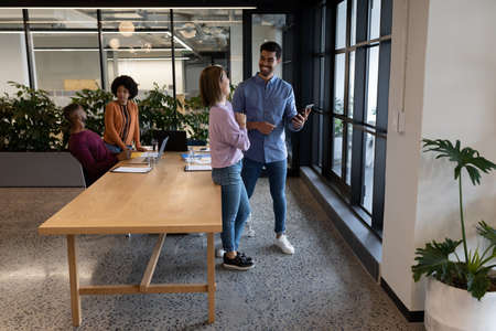 Diverse group of business people working in creative office. group of people in a meeting discussing...