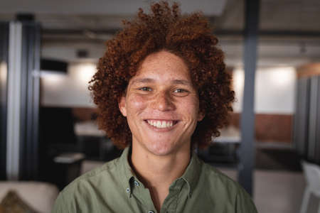 Portrait of happy mixed race businessman standing at the office room smiling. independent creative...