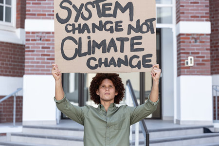 Portrait of mixed race man holding placard. equal rights and justice protestors on demonstration...