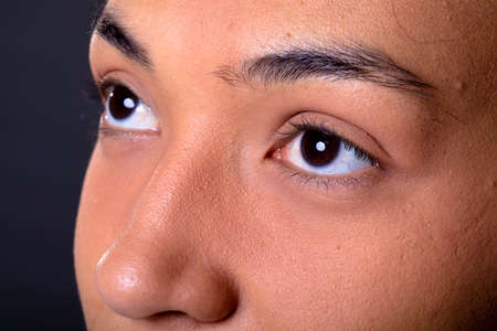 Close up of eyes of african american businesswoman against grey background. business and...