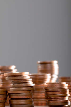 Close up of piles of coins on table, isolated on grey background. business technology, communication...