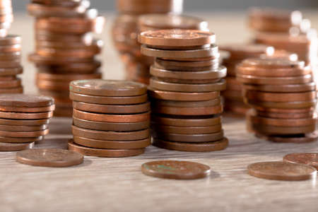 Close up of piles of coins on table, isolated on grey background. business technology, communication...